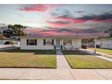 Charming single-story home with a well-maintained lawn and covered front entrance at 7108 Stockholm Way, Orlando, FL 32822