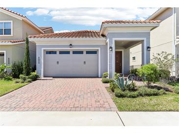 Charming single-Gathering home with a red brick driveway and well-manicured landscaping at 8006 Hoylake Dr, Orlando, FL 32832