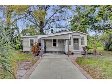 Charming single-story home with a covered carport and well-maintained front yard at 1407 Lantry Ct, Orlando, FL 32804