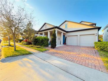 Charming two-story home featuring a three-car garage, manicured landscaping and a welcoming front porch at 14675 Scott Key Dr, Winter Garden, FL 34787