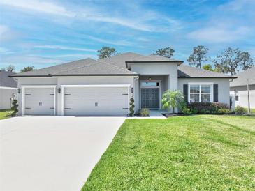 Charming single-story home featuring a three-car garage and a well-maintained lawn with mature landscaping at 149 St Thomas Dr, Mulberry, FL 33860