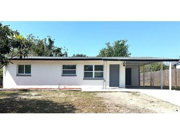 Charming single-story home featuring a carport and freshly painted exterior, creating a welcoming curb appeal at 300 S Aurora Dr, Apopka, FL 32703