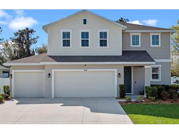 Charming two-story home with a three-car garage and well-maintained landscaping in a suburban neighborhood at 31807 Broadwater Ave, Leesburg, FL 34748