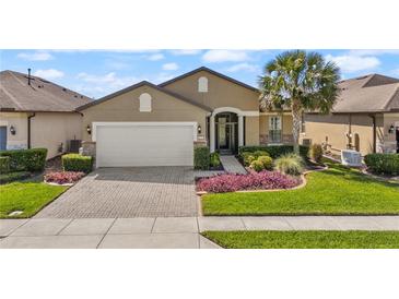 Charming single-story home with brick paved driveway and meticulously manicured landscaping at 846 Asturias Rd, Davenport, FL 33837