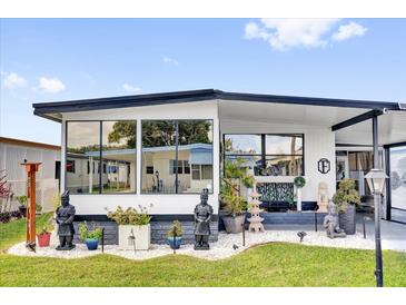 Beautiful home exterior with manicured lawn, stone accents and decorative statuary at 1401 W Highway 50 # 45, Clermont, FL 34711