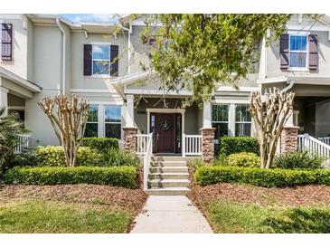 Inviting townhouse with well-manicured landscaping and charming front porch at 15580 Blackbead St, Winter Garden, FL 34787