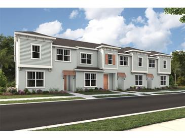 New townhome construction shows clean lines and modern design, complementing a lovely street at 2327 Distant Sun Trl, Kissimmee, FL 34747