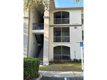 Condo building featuring a stairway to the units and screened in balconies at 2717 Maitland Crossing Way # 4-103, Orlando, FL 32810