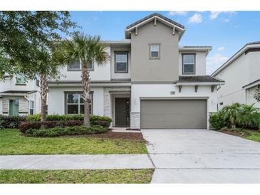Charming two-story home with a two-car garage and well-maintained landscaping at 418 Marcello Blvd, Kissimmee, FL 34746