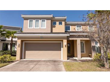 Inviting front exterior of a two-story home with a two-car garage, well-maintained lawn, and lovely landscaping at 4561 Cabello Loop, Kissimmee, FL 34746