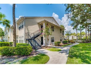 Inviting two-story condo with beautiful landscaping, convenient stair access, and well-maintained surroundings at 1033 S Hiawassee Rd # 2628, Orlando, FL 32835