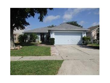 Charming single-story home featuring a well-maintained lawn and a two-car garage in a peaceful neighborhood at 2014 Corner Meadow Cir, Orlando, FL 32820