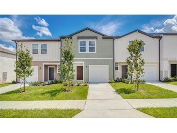 Inviting townhomes with manicured lawns, sidewalks, and attached garages at 3483 Vesara Dr, Davenport, FL 33837