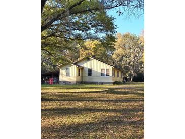 Charming single-story home with a classic design and a spacious front yard with mature trees at 7438 Vivian Ln, Orlando, FL 32818