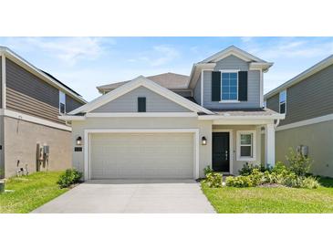 Charming two-story home with a two-car garage, well-maintained lawn, and attractive curb appeal at 132 Adventure Ave, Davenport, FL 33837