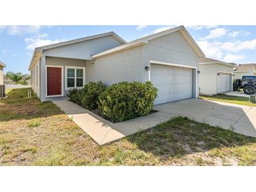 Charming single-story home with a two-car garage and well-maintained landscaping at 2956 Whispering Trails Dr, Winter Haven, FL 33884