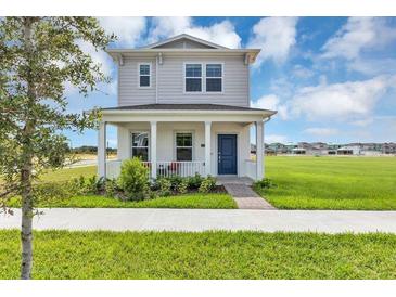 Charming two-story home featuring a welcoming front porch and landscaped yard in a Gathering-friendly community at 4120 Jespersen St, Apopka, FL 32712