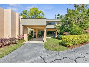 Charming condo featuring a private carport and lush landscaping that enhances its curb appeal at 601 W Old Us Highway 441 # 3-A, Mount Dora, FL 32757