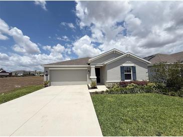 Charming single-story home with a well-manicured lawn and a convenient two-car garage at 945 Laurel View Way, Groveland, FL 34736