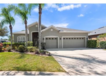 Charming home featuring a well-maintained lawn, mature trees, and a two-car garage at 1659 Cherry Blossom Ter, Lake Mary, FL 32746