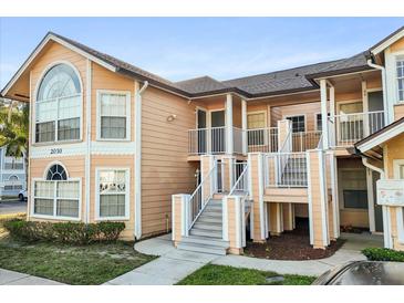 Charming two-story condo with inviting stairs and beautiful architectural details on a sunny day at 2030 Royal Bay Blvd # 62, Kissimmee, FL 34746