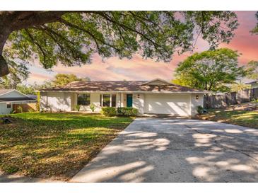 Charming single-story home featuring a well-manicured lawn and inviting curb appeal with mature trees and a long driveway at 2661 Jennifer Hope Blvd, Longwood, FL 32779