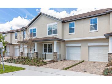 Charming townhome featuring a private garage and landscaped front yard at 4409 Summer Flowers Pl, Kissimmee, FL 34746