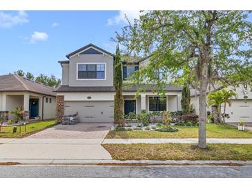 Charming two-story home with well-manicured landscaping, inviting curb appeal, and attached two car garage at 5116 Sorrento W Blvd, St Cloud, FL 34771