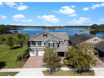 Beautiful two-story home with a two-car garage and a well-manicured lawn overlooking a serene lake at 10303 Atwater Bay Dr, Winter Garden, FL 34787