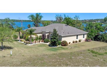Sprawling single story home with beautiful landscaping and lake views at 16752 Caravaggio Loop, Montverde, FL 34756