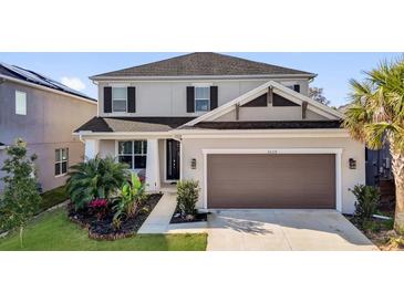 Charming two-story home featuring an attached two-car garage and well-manicured landscaping at 3029 High Pointe St, Clermont, FL 34711