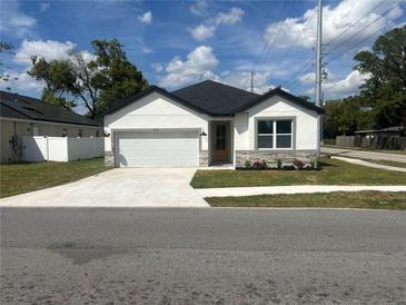 Charming single-story home with a well-manicured lawn and a concrete driveway at 493 E Palmetto Ave, Longwood, FL 32750