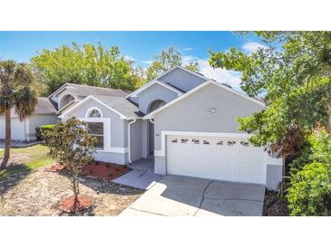 Charming single-story home featuring a two-car garage, well-maintained landscaping, and a freshly painted exterior at 6921 Blair Dr, Orlando, FL 32818