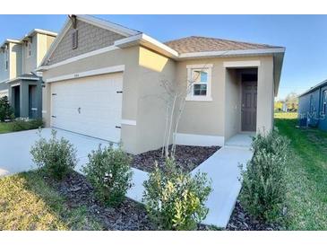 Charming single-story home with a two-car garage and well-maintained landscaping at 994 King Parc Rd, Orange City, FL 32763