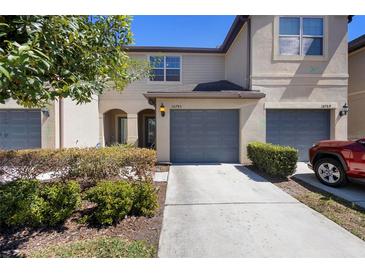 Charming townhome with a well-manicured front yard and attached two-car garage at 10785 Corsican St # 3, Orlando, FL 32824