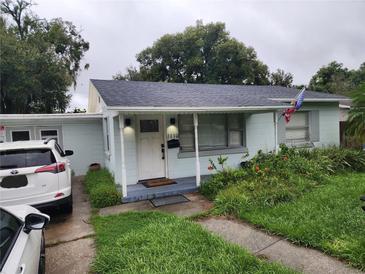 Charming single-story home with well-maintained landscaping and covered front porch with seating area at 1110 E Edgewood Dr, Lakeland, FL 33803