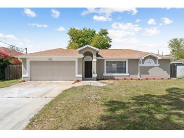 Charming single-story home with a well-manicured lawn, neutral paint, and an attached one-car garage at 1456 Providence Blvd, Deltona, FL 32725