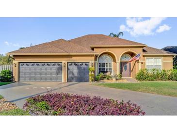 Charming home with a well-manicured lawn and a spacious three-car garage at 158 Cedar Springs Cir, Debary, FL 32713