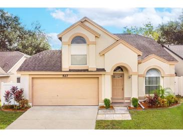 Charming two-story home with a well-manicured lawn and attached two-car garage, located in a desirable neighborhood at 527 Huxford Ct, Lake Mary, FL 32746