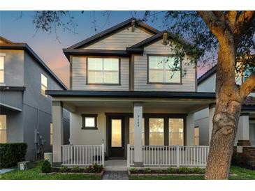 Charming two-story home featuring a welcoming front porch and beautifully maintained landscaping at 9149 Grand Island Way, Winter Garden, FL 34787