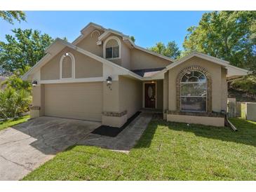 Charming single-Gathering home with a two-car garage, inviting curb appeal and a well-manicured lawn at 936 Summer Lakes Dr, Orlando, FL 32835