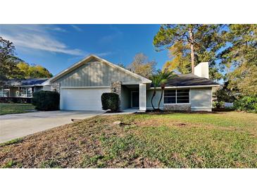 Charming single-Gathering home featuring stone accents, a two-car garage, and a well-maintained lawn at 202 Ramsbury Ct, Longwood, FL 32779