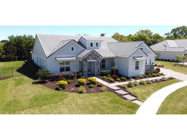 Charming single-story home featuring stone accents, manicured lawn, and inviting walkway at 2055 Quiet Cv, Sanford, FL 32771