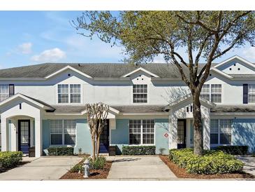 Charming townhome featuring light blue paint, and neatly trimmed landscaping at 2546 Maneshaw Ln, Kissimmee, FL 34747