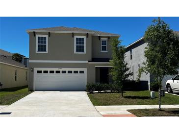 Charming two-story home featuring a two-car garage and well-maintained front lawn in a suburban neighborhood at 2597 Shamrock St, Tavares, FL 32778