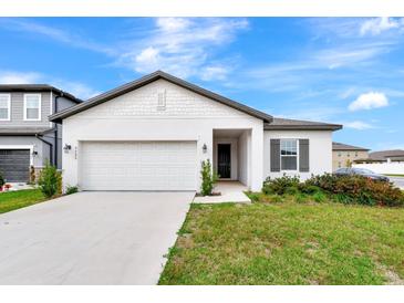 Charming single-Gathering home with a two-car garage, well-maintained lawn, and inviting curb appeal at 5733 Iron Brand Rd, St Cloud, FL 34771