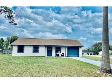Charming single-story home with a well-maintained lawn and a blue-trimmed exterior at 1795 Orange View Ct, Kissimmee, FL 34746