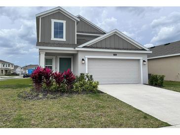 Charming two-story home with a well-manicured lawn and a two car garage at 1902 Presley Pl, Kissimmee, FL 34746