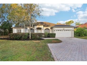 Inviting single-story home featuring a brick driveway and well-maintained front yard at 250 Lakeridge Ct, Winter Springs, FL 32708