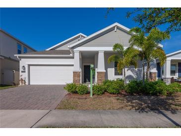 Charming single-Gathering home showcasing a two-car garage, and a well-manicured lawn at 2750 Slash Way, St Cloud, FL 34771